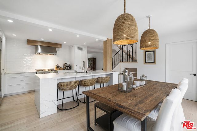 a dining room with a table chairs and a wooden floor