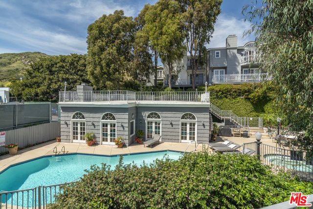 front view of a house with a swimming pool