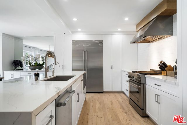 a kitchen with a sink stove and refrigerator