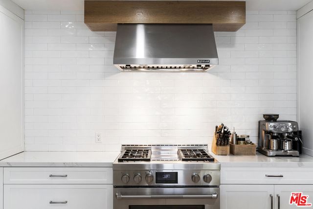 a stove top oven sitting inside of a kitchen