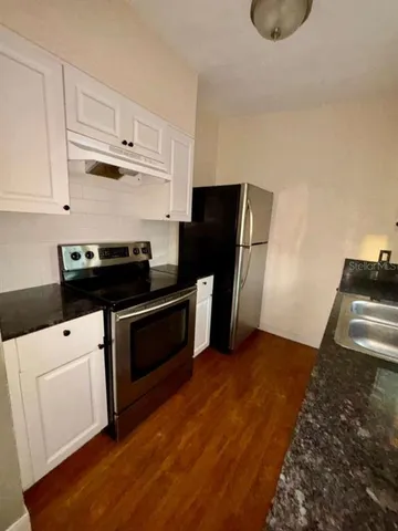a kitchen with a stove and a refrigerator