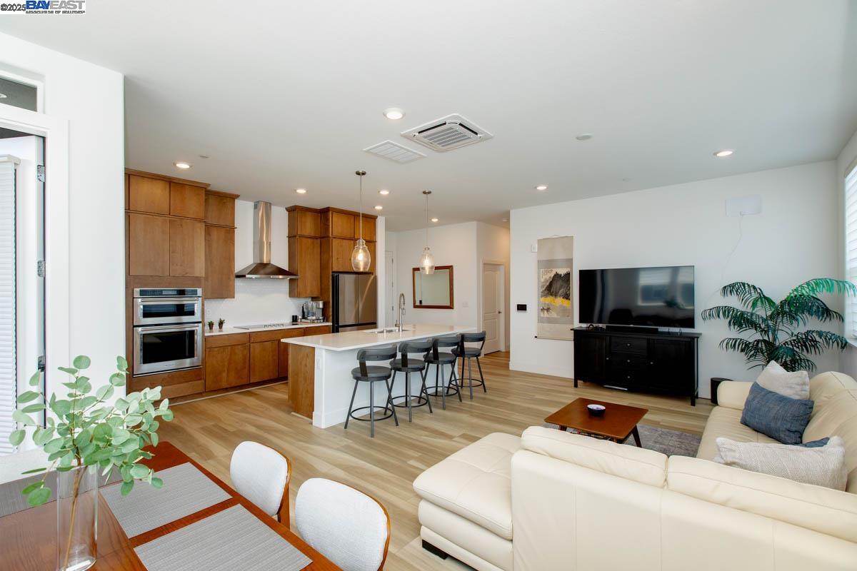 2885 Tradewind Drive Alameda, CA 94501 - Photo 6 of 12 a living room with furniture kitchen view and a potted plant