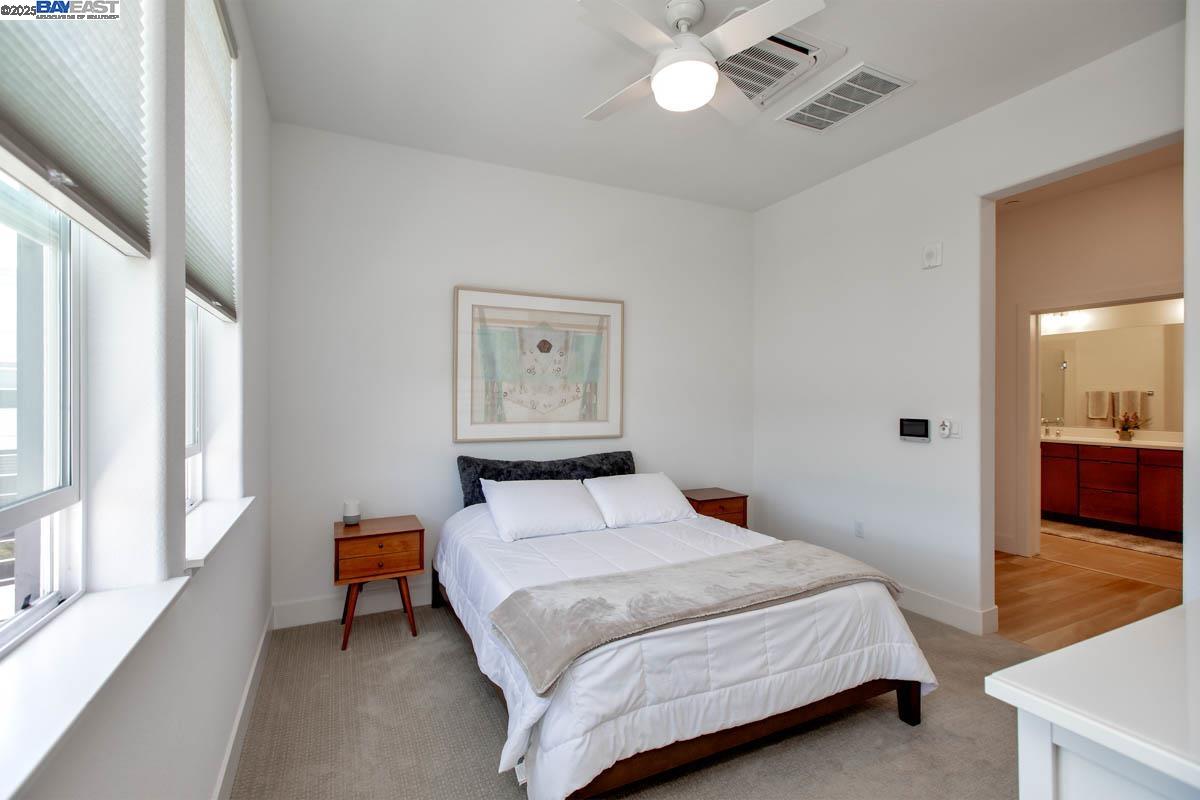 2885 Tradewind Drive Alameda, CA 94501 - Photo 8 of 12 a bedroom with a bed and a view of bathroom
