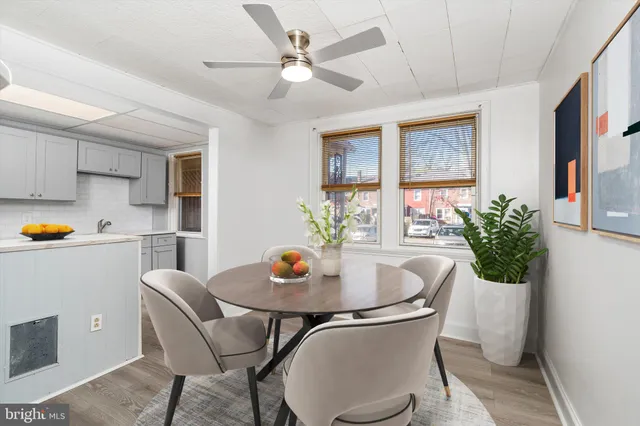 a view of a dining room with furniture and a potted plant