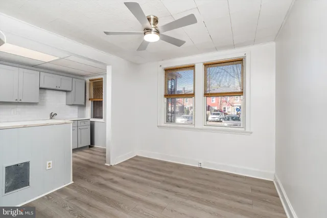a view of a kitchen with wooden floor and a window