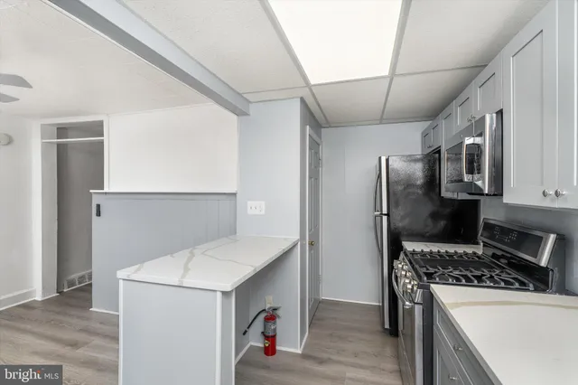 a kitchen that has a microwave and a stove