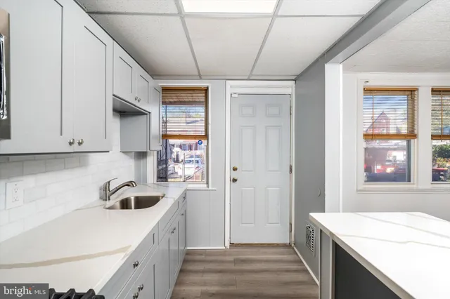 a kitchen that has a sink and a stove in it