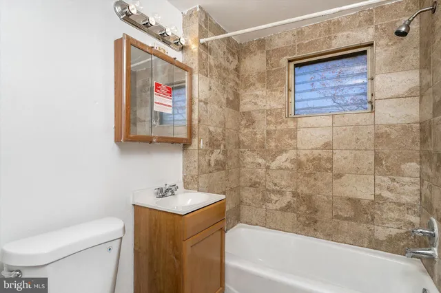 a bathroom with a toilet a sink and bathtub