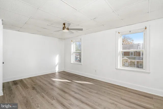 wooden floor in an empty room with a window