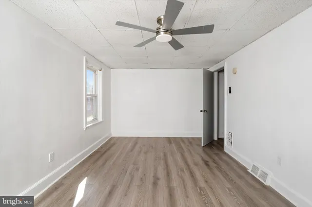 wooden floor in an empty room with a window