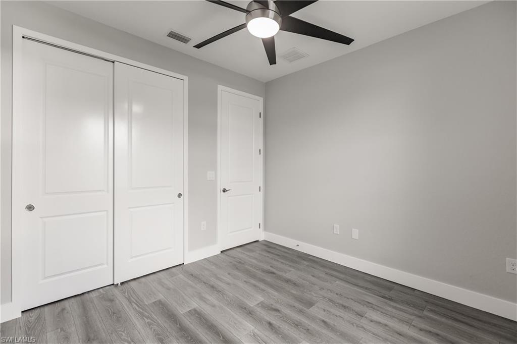 26395-26397 Explorer Road Punta Gorda, FL 33983 - Photo 14 of 18 a view of an empty room with wooden floor