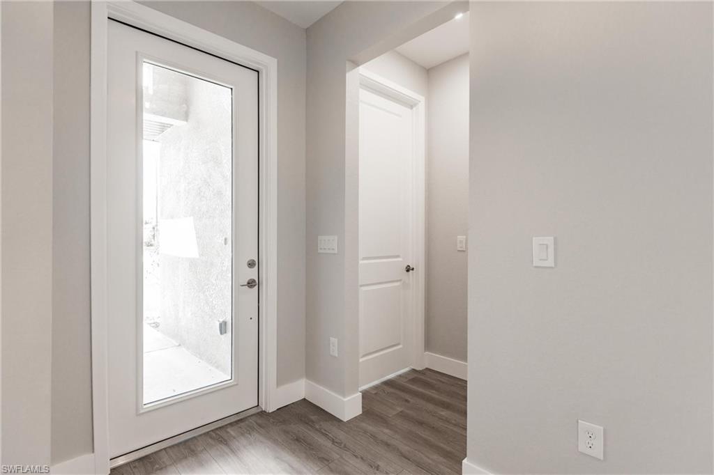 26395-26397 Explorer Road Punta Gorda, FL 33983 - Photo 3 of 18 a view of a hallway with wooden floor