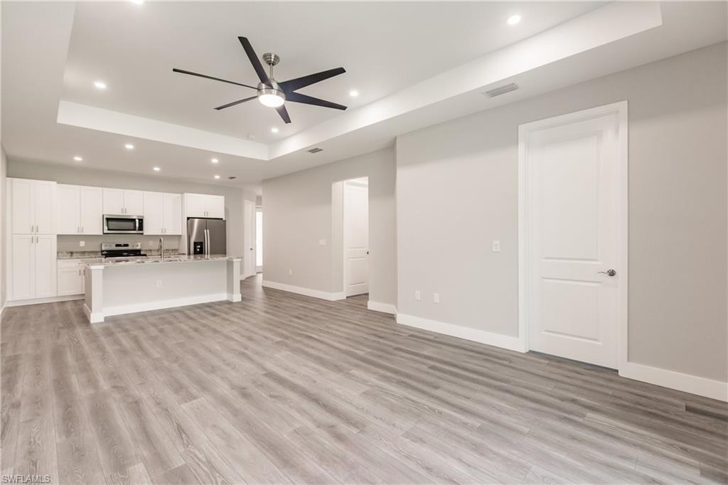 26395-26397 Explorer Road Punta Gorda, FL 33983 - Photo 6 of 18 a view of kitchen with refrigerator microwave and wooden floor