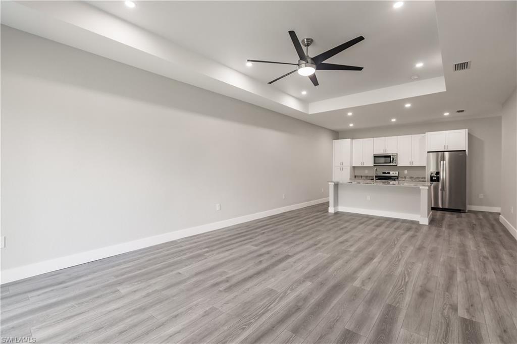 26395-26397 Explorer Road Punta Gorda, FL 33983 - Photo 7 of 18 a view of a livingroom with a ceiling fan hardwood floor and a ceiling fan