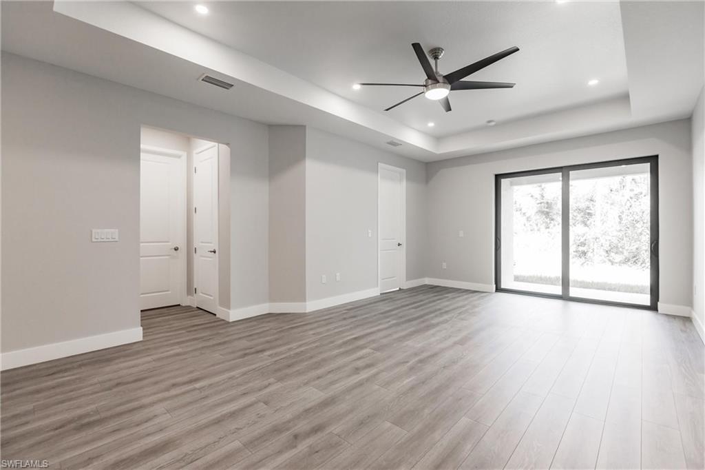 26395-26397 Explorer Road Punta Gorda, FL 33983 - Photo 8 of 18 a view of an empty room with wooden floor and a window