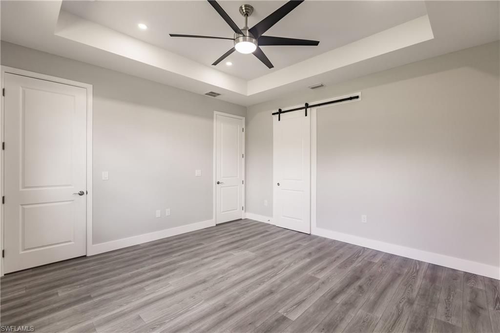 26395-26397 Explorer Road Punta Gorda, FL 33983 - Photo 9 of 18 wooden floor in an empty room