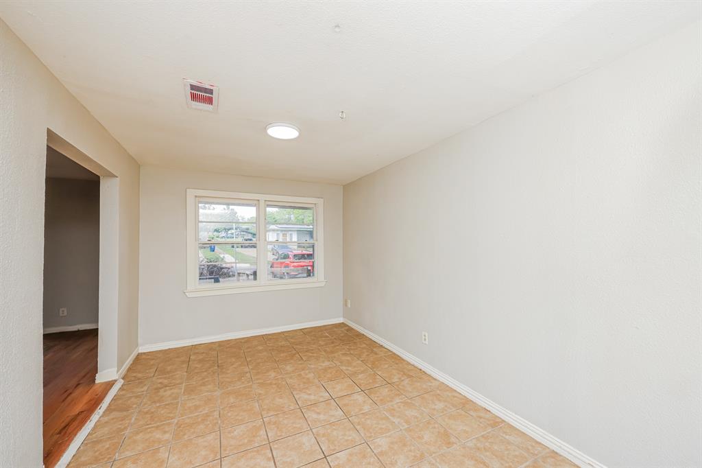 5175 Cardiff Street Dallas, TX 75241 - Photo 11 of 16 The room features light-colored walls, a window with a white frame, and a tiled floor