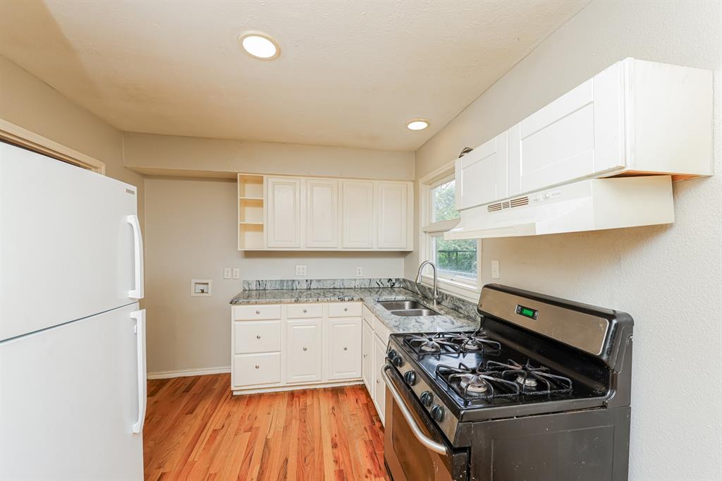 5175 Cardiff Street Dallas, TX 75241 - Photo 5 of 16 The kitchen features hardwood flooring, white cabinetry, granite countertops, and a double basin stainless steel sink