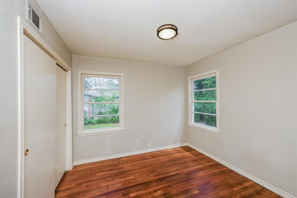 5175 Cardiff Street Dallas, TX 75241 - Photo 8 of 16 This room features rich hardwood flooring, two windows providing natural light, a closet with sliding doors, and a ceiling-mounted light fixture
