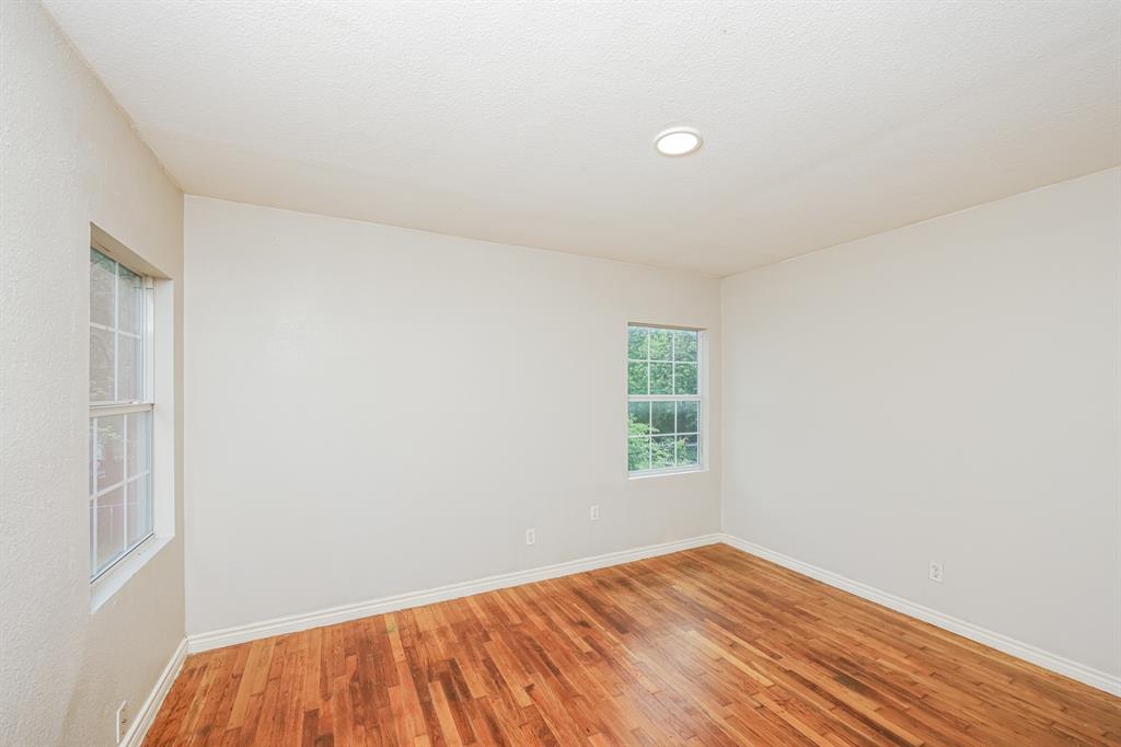 5175 Cardiff Street Dallas, TX 75241 - Photo 10 of 16 This room features rich hardwood flooring and two windows providing natural light