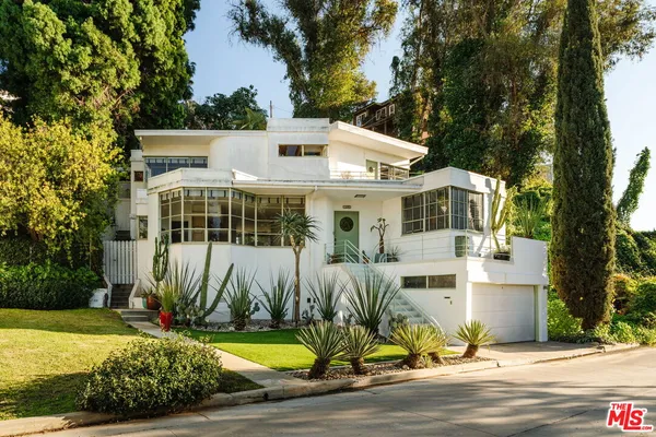 a view of house with outdoor space and swimming pool