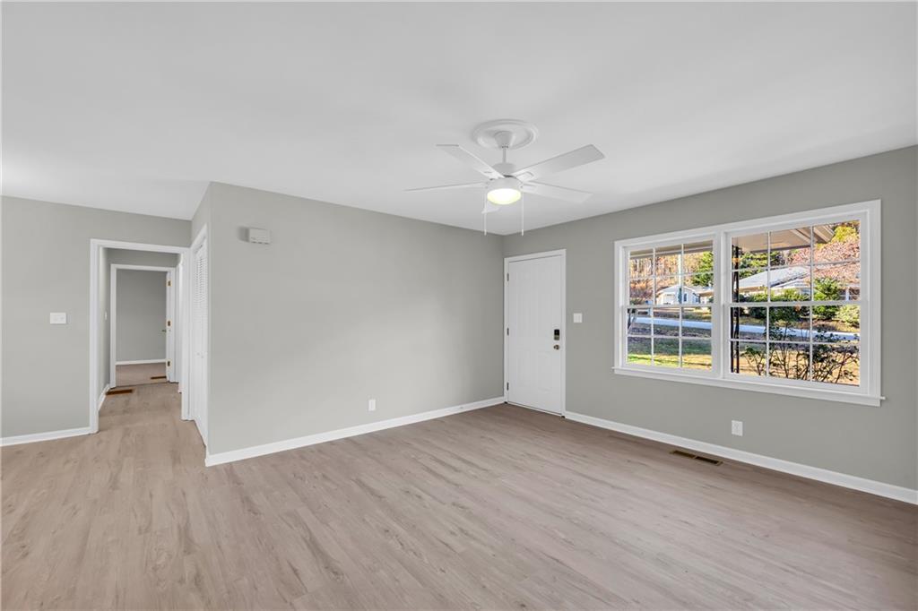 75 Cawthon Road Toccoa, GA 30577 - Photo 12 of 28 a view of an empty room with a window and wooden floor