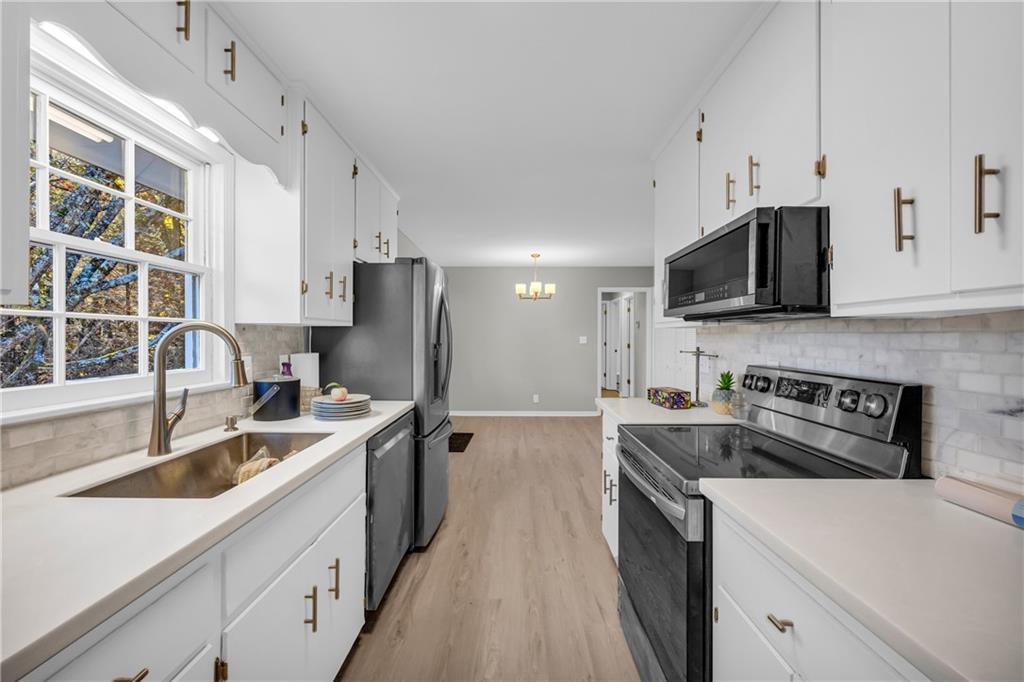 75 Cawthon Road Toccoa, GA 30577 - Photo 16 of 28 a kitchen with stainless steel appliances granite countertop a sink stove and refrigerator