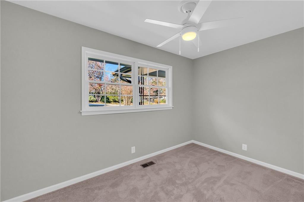 75 Cawthon Road Toccoa, GA 30577 - Photo 18 of 28 an empty room with a window and a ceiling fan