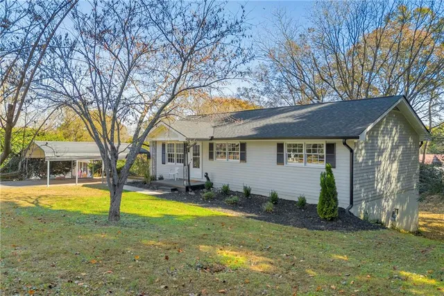 a view of a house with swimming pool and sitting area