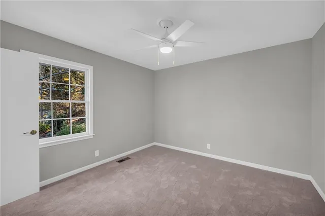 an empty room with windows and entrance