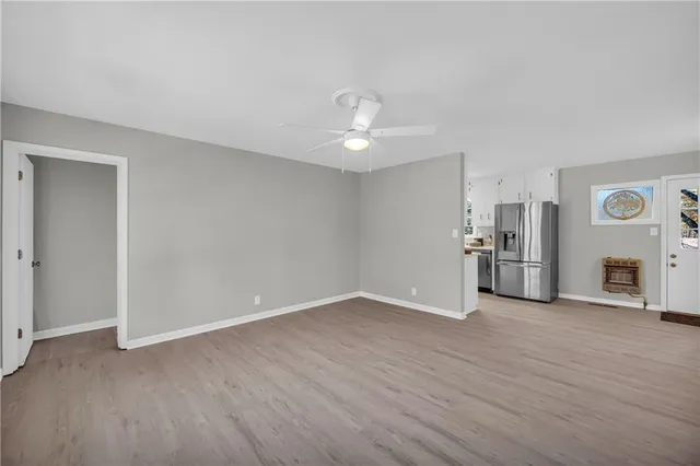 a view of a kitchen with a sink and a refrigerator