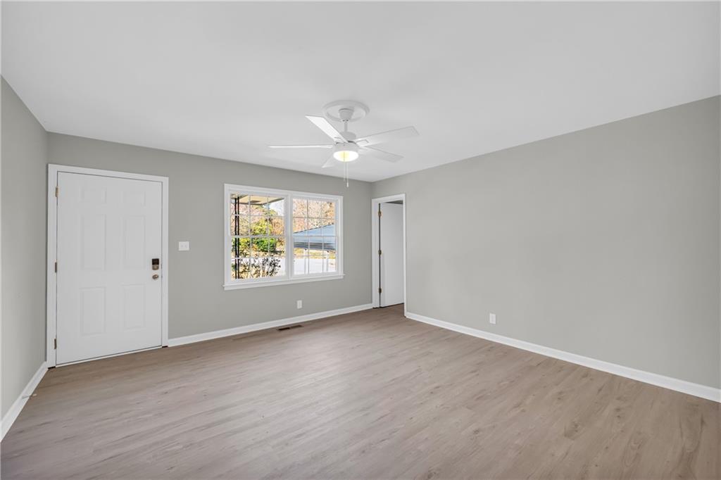 75 Cawthon Road Toccoa, GA 30577 - Photo 10 of 28 an empty room with windows and a ceiling fan