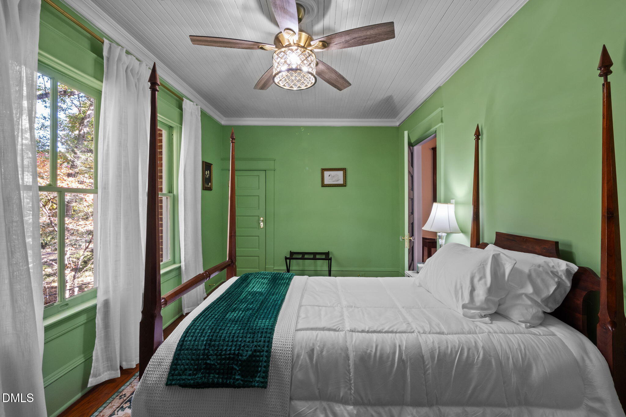 7891 Boston Road Roxboro, NC 27574 - Photo 44 of 85 a bedroom with a large bed and a chandelier
