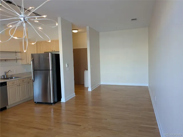a view of a kitchen with a refrigerator and a sink