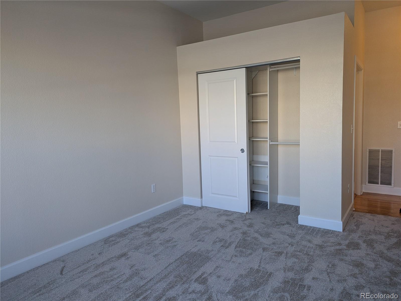 5677 South Park Place, Unit C204 Englewood, CO 80111 - Photo 9 of 13 an empty room with closet and mirror