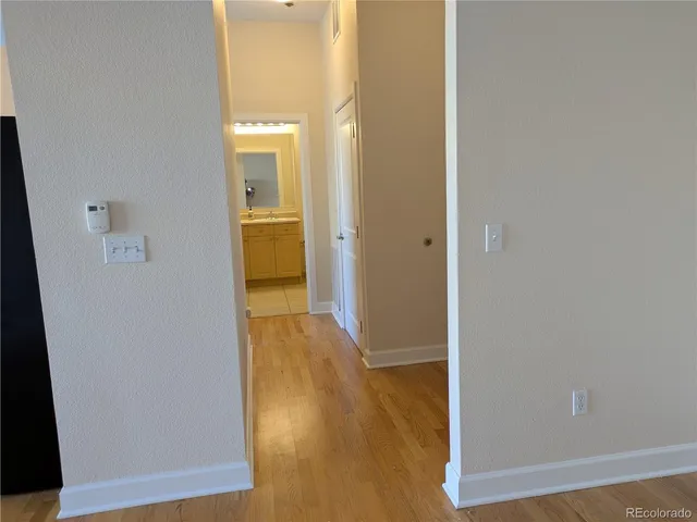 a view of a hallway with wooden floor