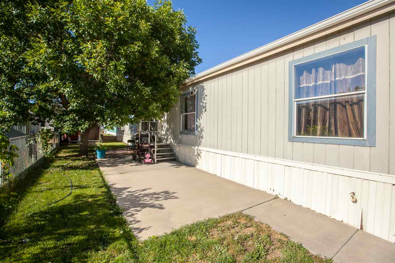 424 32 Road, Unit 292 Clifton, CO 81520 - Photo 31 of 35 a view of a backyard with a large tree