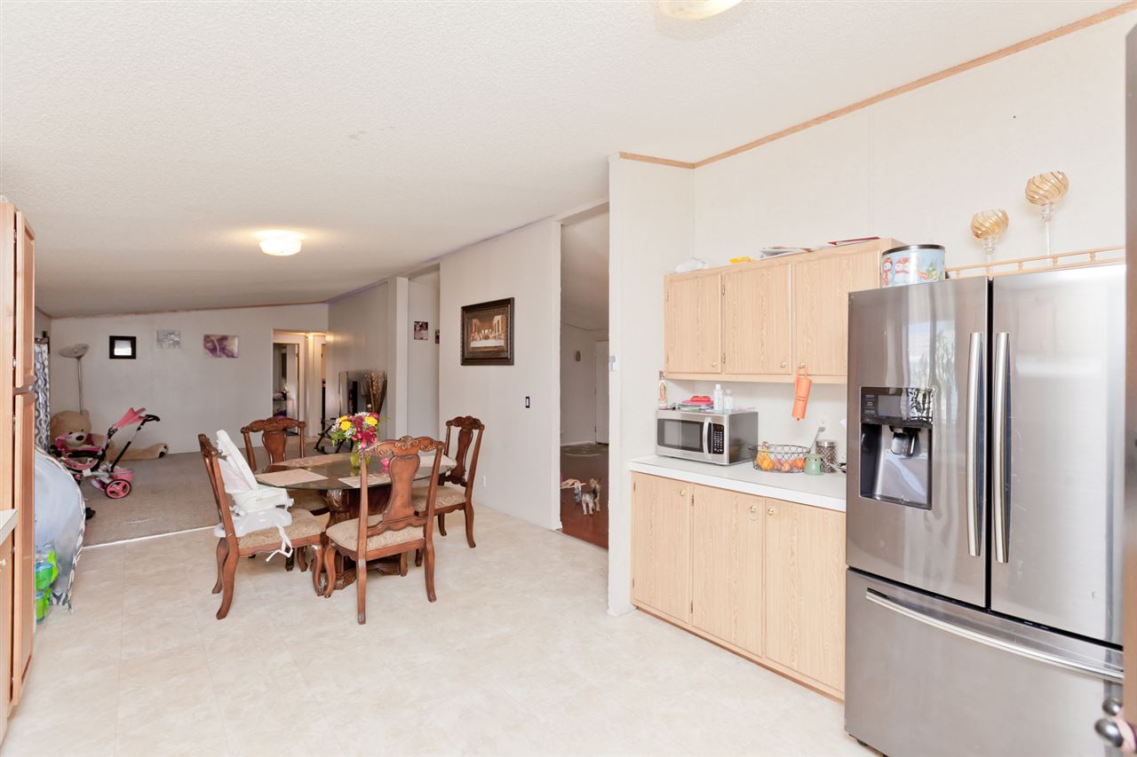 424 32 Road, Unit 292 Clifton, CO 81520 - Photo 6 of 35 a view of a dining room with furniture a kitchen and a chandelier