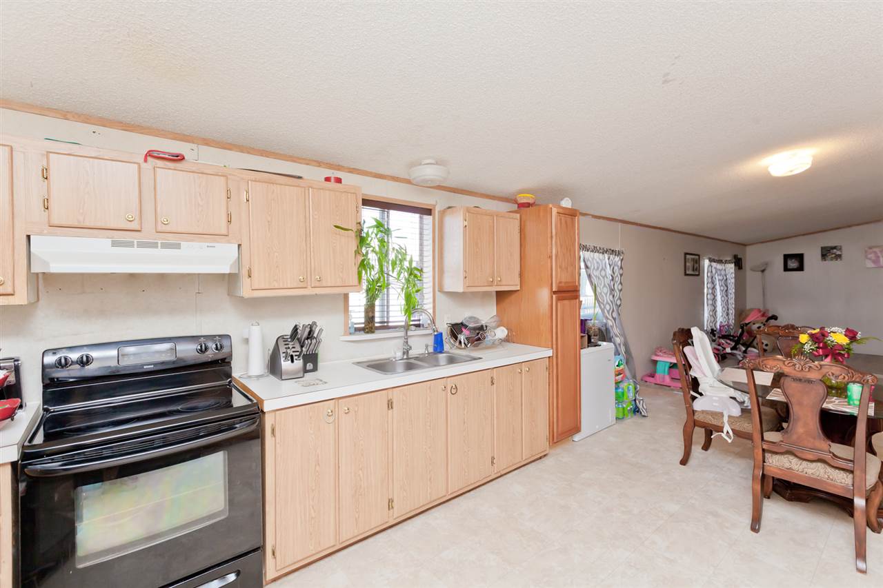 424 32 Road, Unit 292 Clifton, CO 81520 - Photo 10 of 35 a kitchen with stainless steel appliances a stove a sink cabinets and a window