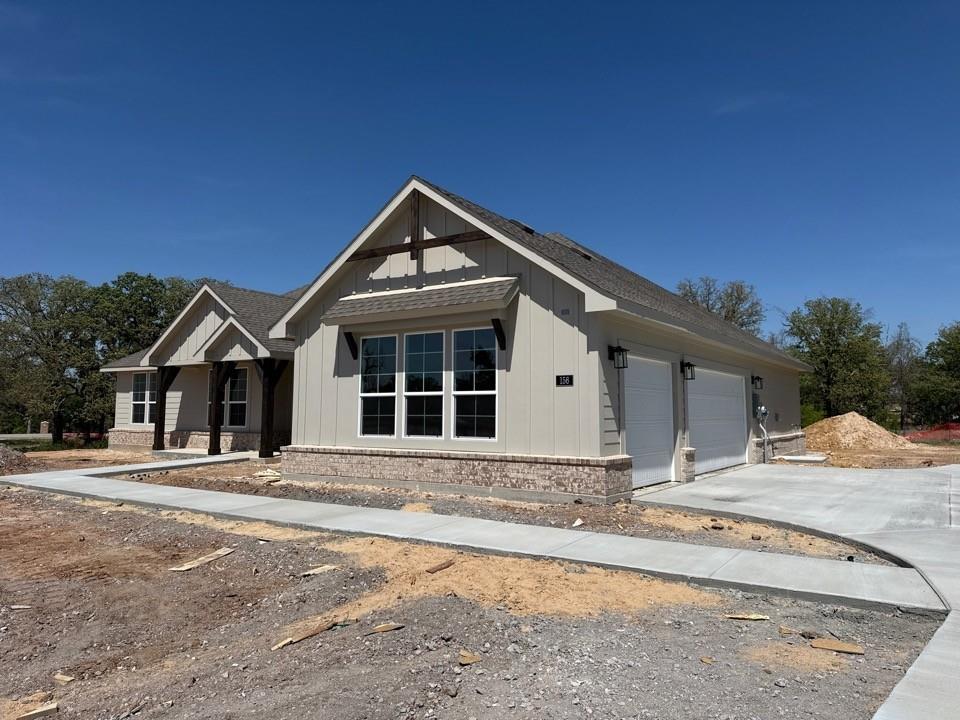 156 Oak Grv Way Springtown, TX 76082 - Photo 3 of 17 a front view of a house with a yard