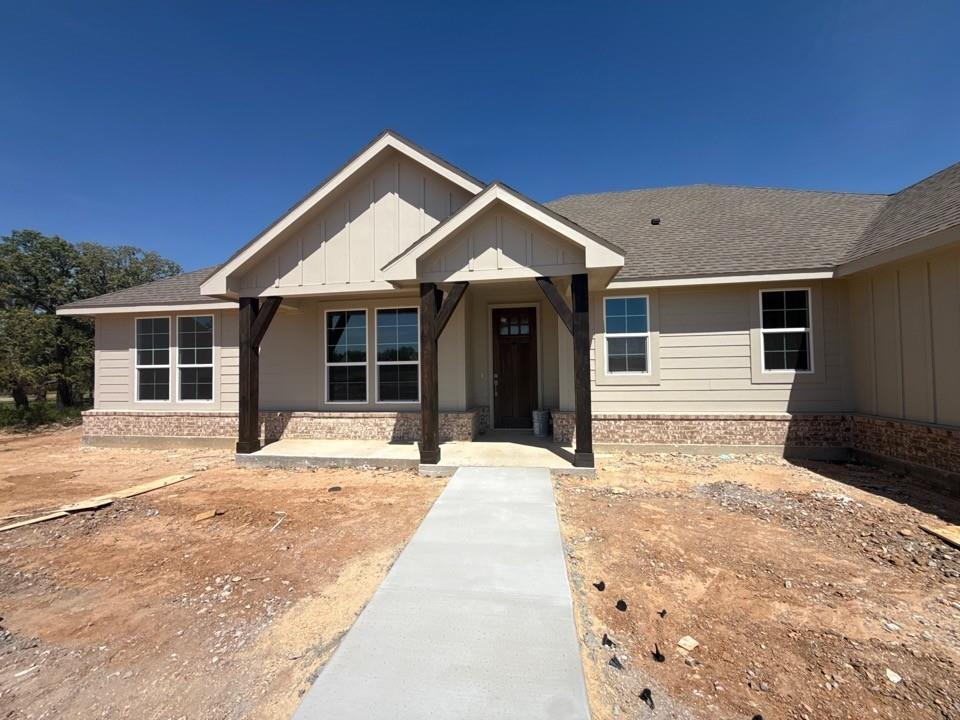 156 Oak Grv Way Springtown, TX 76082 - Photo 4 of 17 a front view of a house with a yard