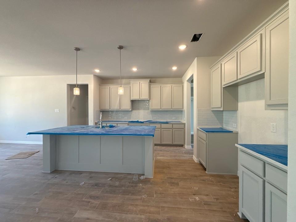 156 Oak Grv Way Springtown, TX 76082 - Photo 6 of 17 a kitchen with kitchen island a sink stainless steel appliances and cabinets