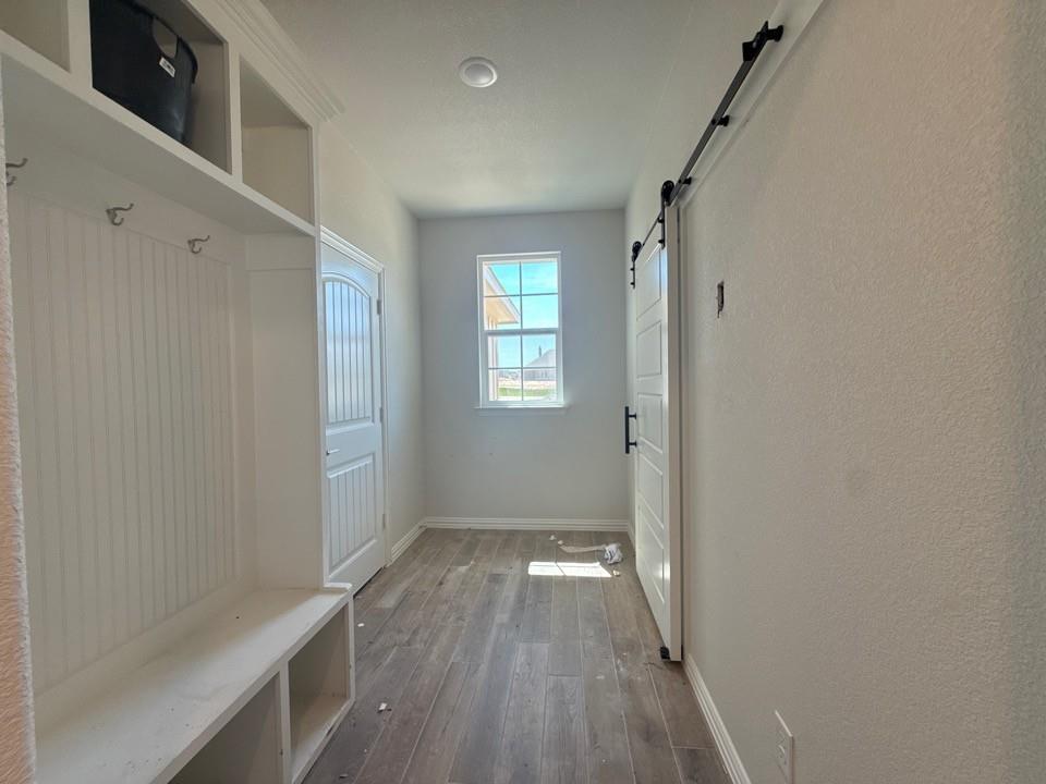 156 Oak Grv Way Springtown, TX 76082 - Photo 9 of 17 a view of hallway with window and wooden floor