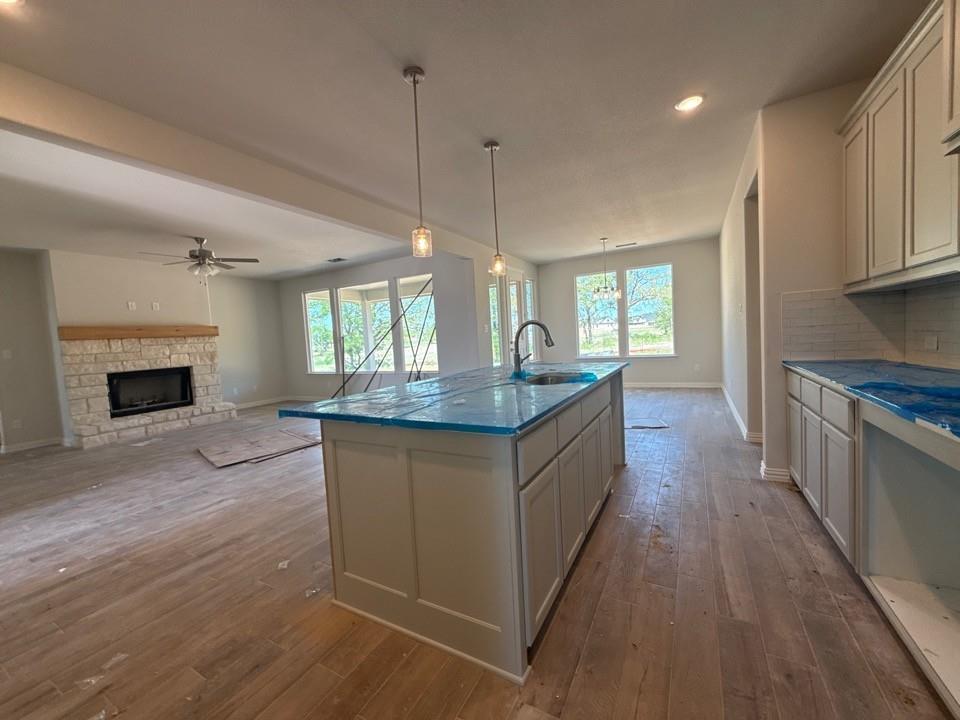 156 Oak Grv Way Springtown, TX 76082 - Photo 10 of 17 a kitchen with granite countertop a stove a sink and a wooden floors