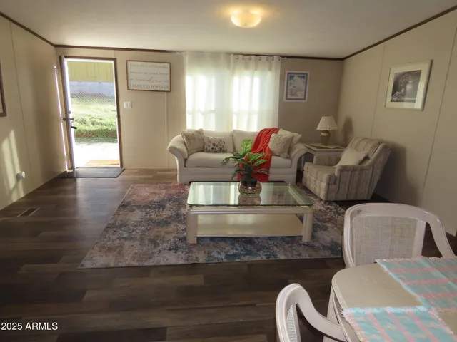 a kitchen with stainless steel appliances granite countertop a refrigerator a stove a sink dishwasher and a refrigerator with wooden floor