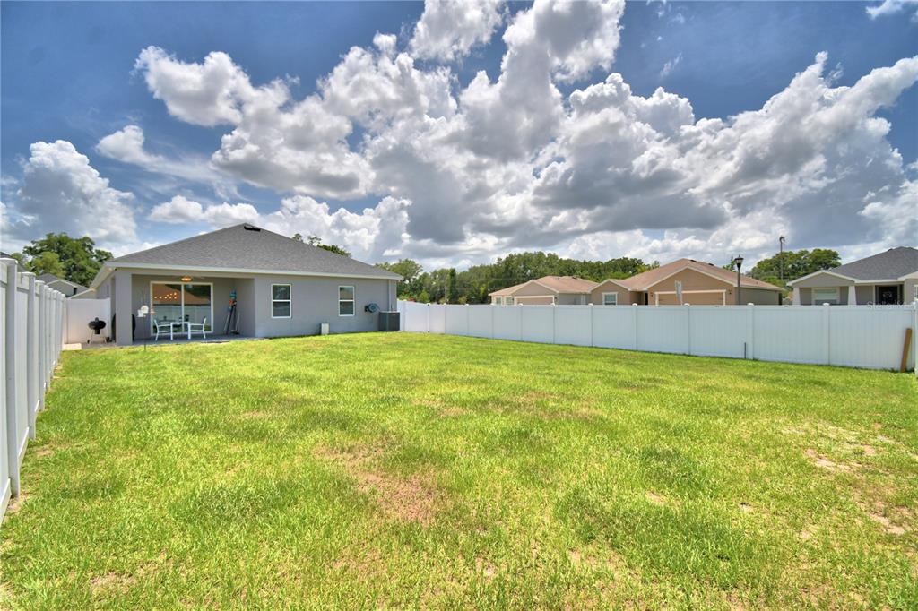4340 Reding Way Lakeland, FL 33813 - Photo 60 of 63 a front view of house with yard and trees in the background
