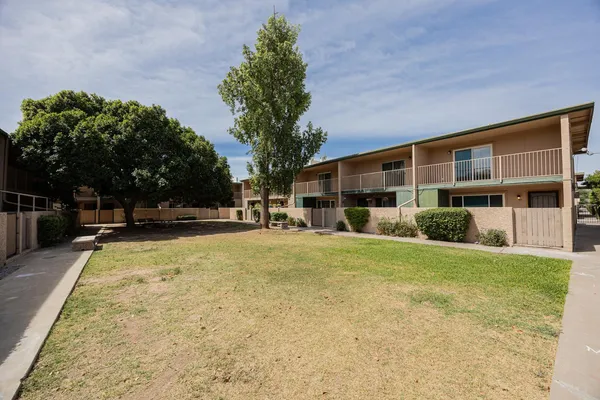 a view of a house with backyard and trees