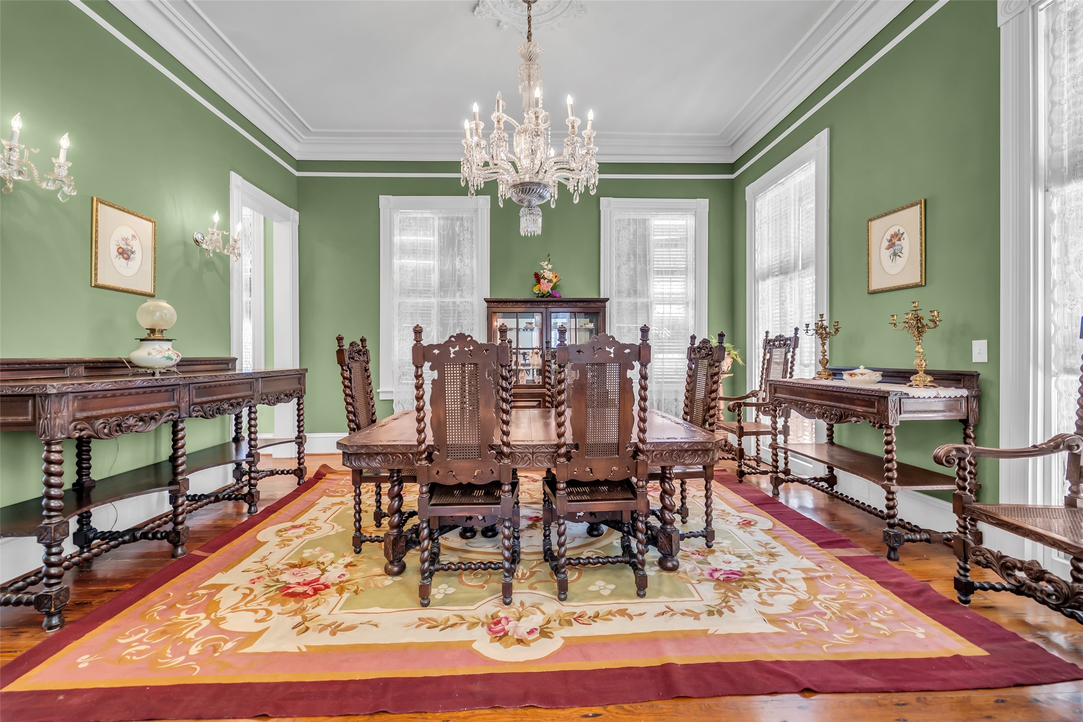 926 Winnie Street Galveston, TX 77550 - Photo 14 of 49 a dining room with wooden floor a chandelier a wooden table and chairs