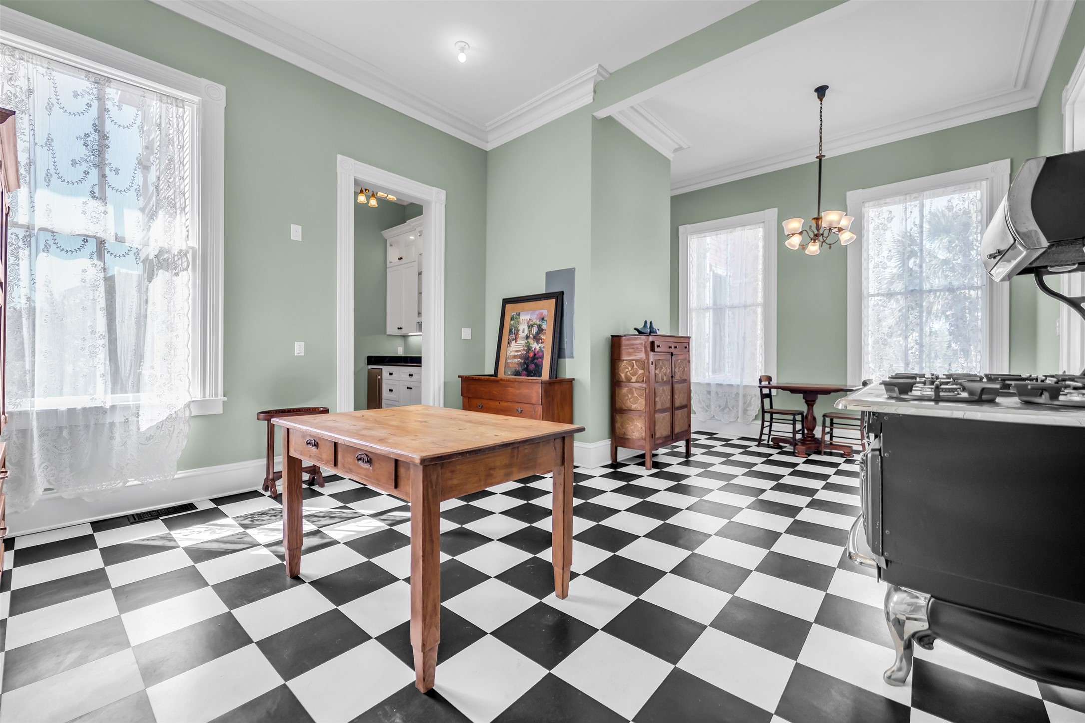 926 Winnie Street Galveston, TX 77550 - Photo 19 of 49 a room with a black white checkered floor with couches chair and a coffee table
