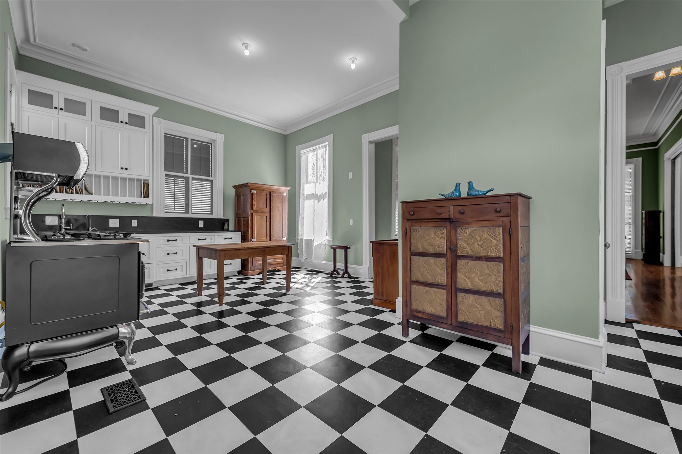 926 Winnie Street Galveston, TX 77550 - Photo 21 of 49 a living room with a black white checkered floor with a gaming machine and appliances